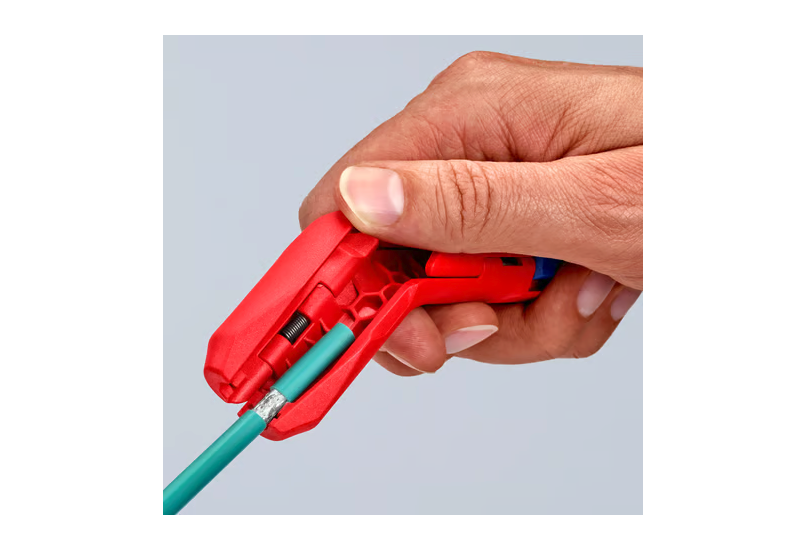 Système de verrouillage et ressort d'ouverture du KNIPEX ErgoStrip® pour une manipulation sécurisée.